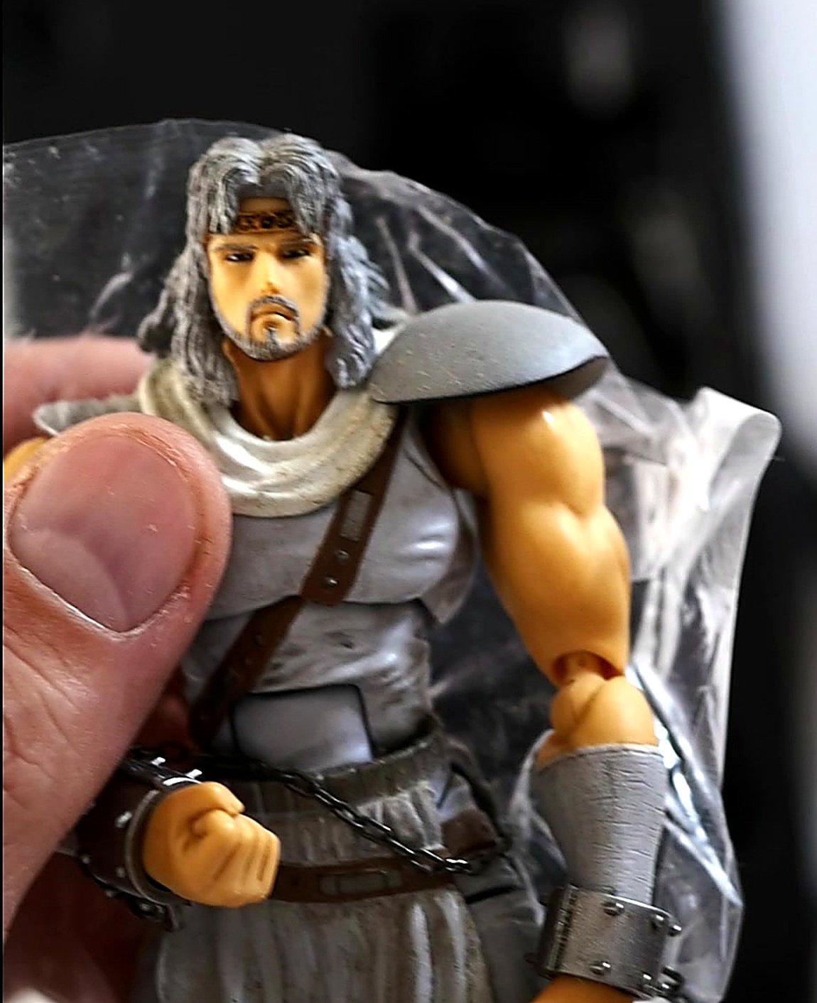 Close-up photo of Toki's face shoulder armor and chest straps