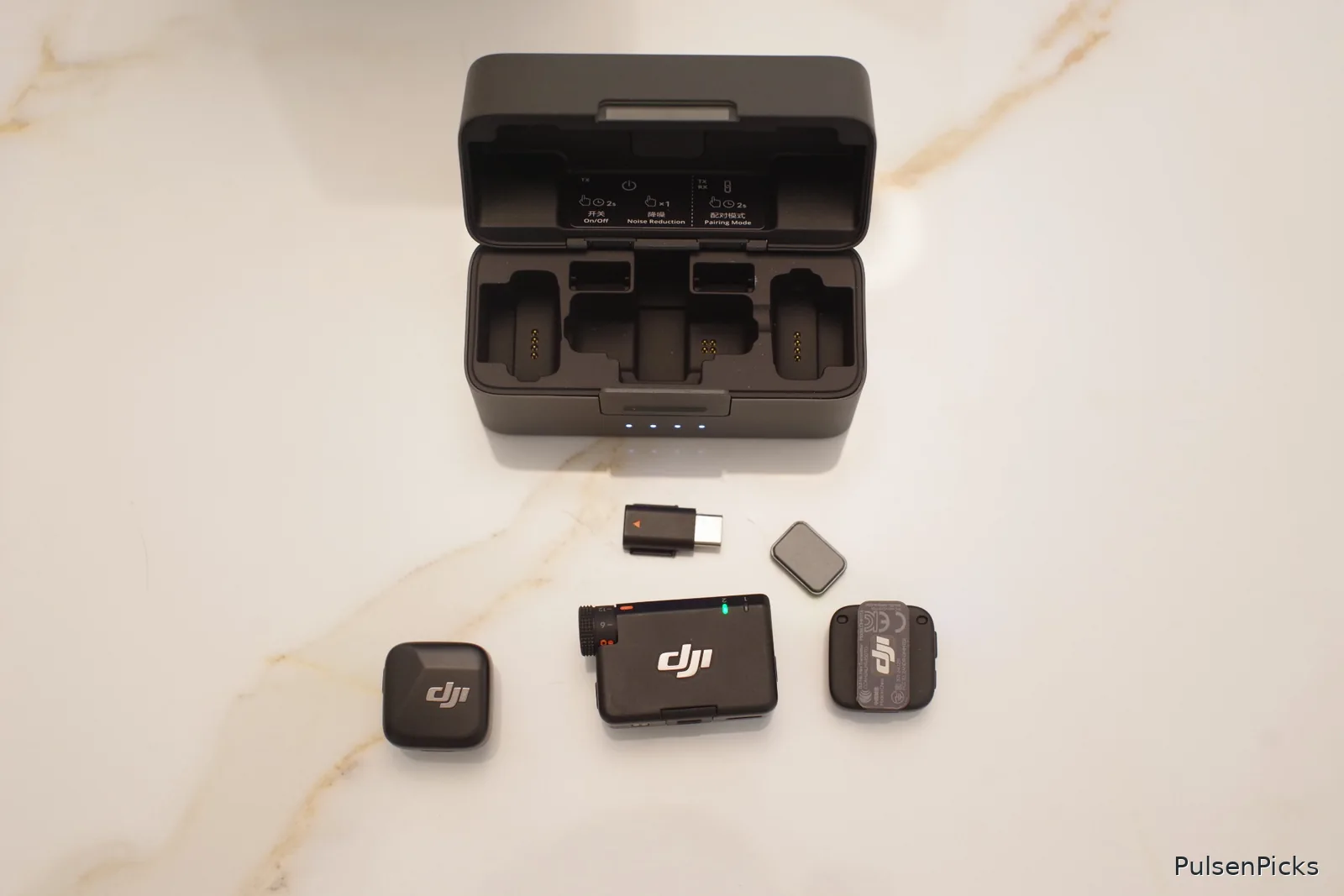 DJI Mic Mini two transmitters receiver USB-C adapter magnetic clip and charging case flat lay