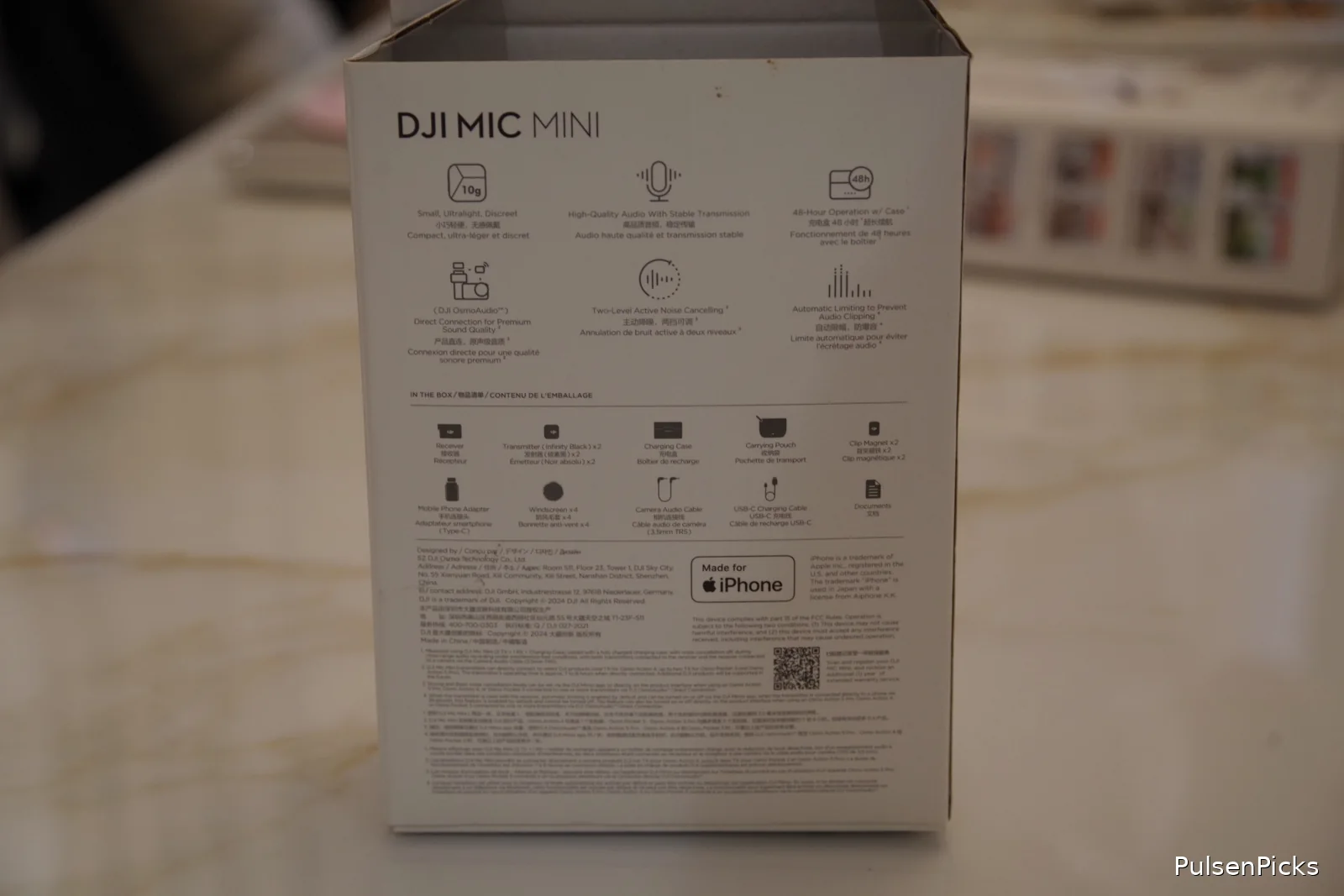 Back of DJI Mic Mini packaging listing two transmitters receiver charging case and accessories