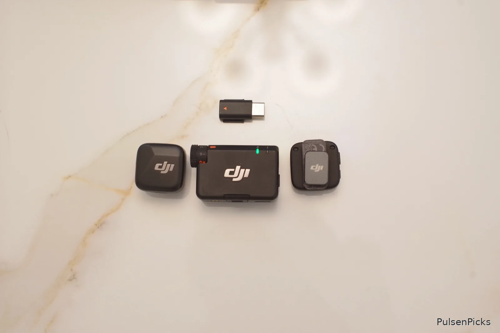 DJI Mic Mini dual wireless microphones with receiver stored in charging case