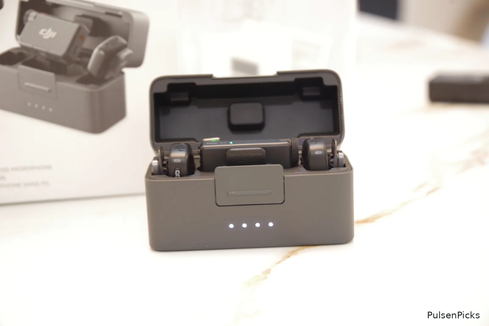 DJI Mic Mini two wireless transmitters and receiver inside open charging case