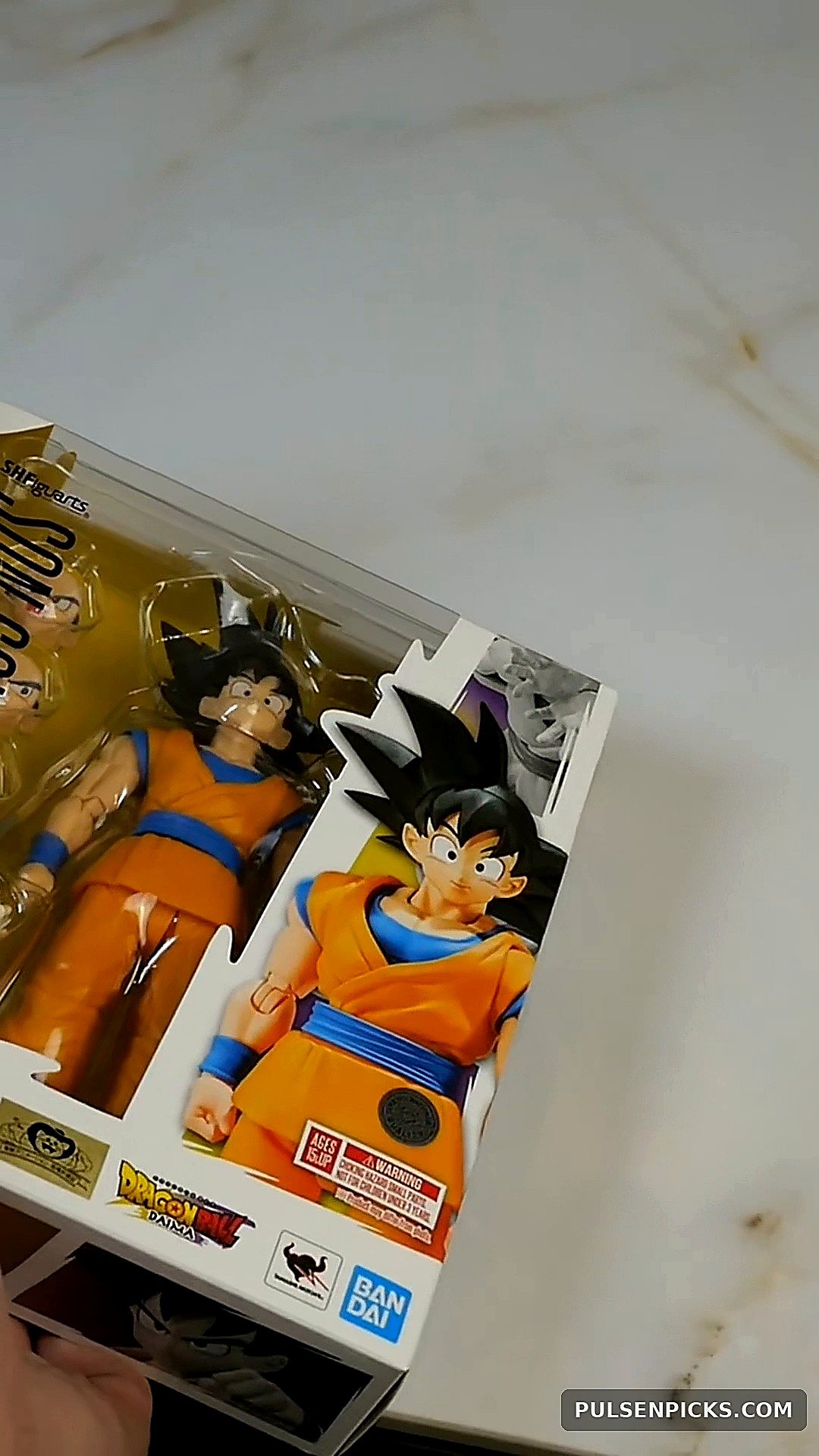 Son Goku DAIMA boxed figure angled on table during unboxing