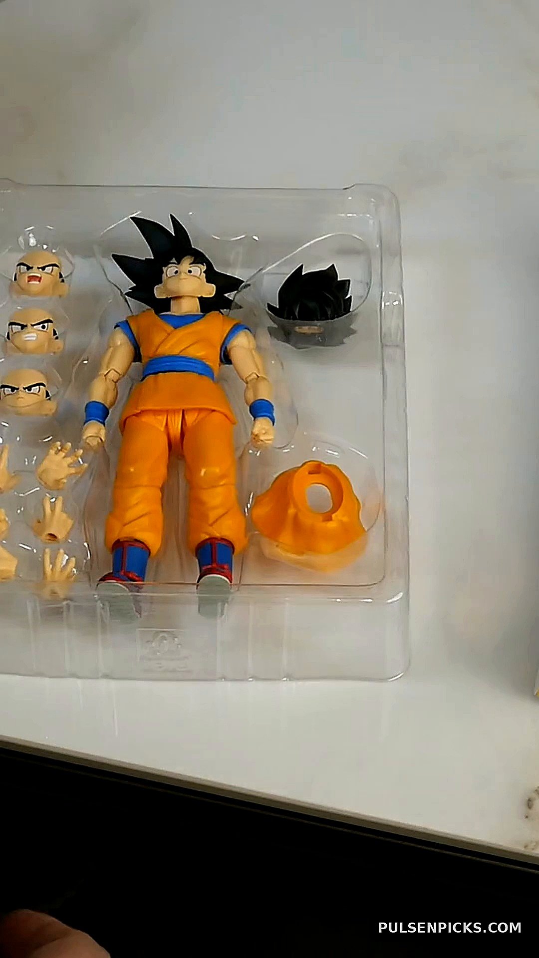 DAIMA Goku body and swap parts visible in plastic tray