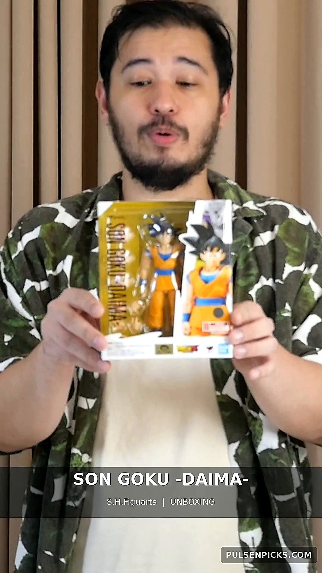 PulseNPicks reviewer holding Bandai Goku DAIMA boxed figure