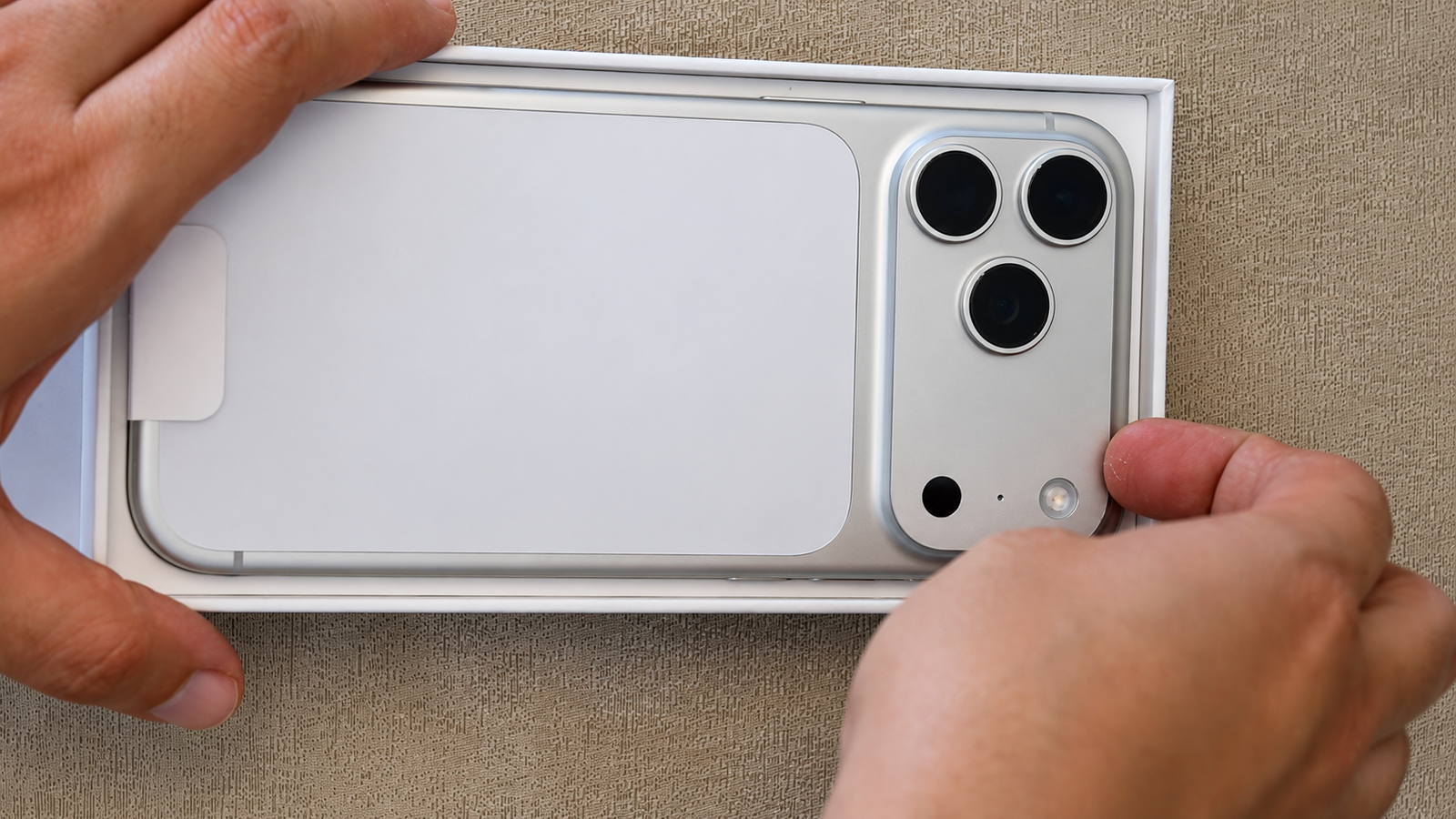iPhone 17 Pro Max in its original packaging, showing the rear camera lenses